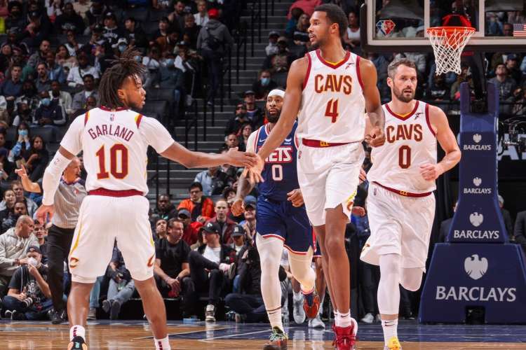 teammates for the cleveland cavaliers high-fiving on the basketball court