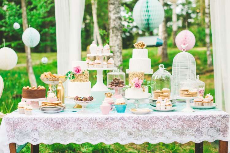 a table full of desserts in an outdoor setting