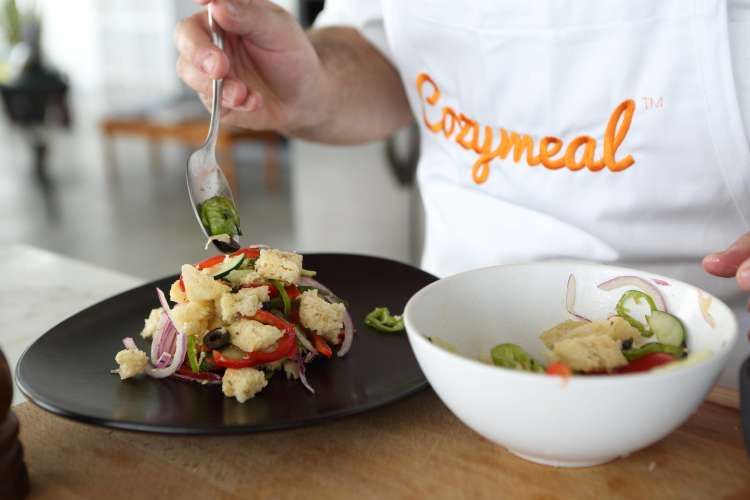 Chef plating a Panzanella salad