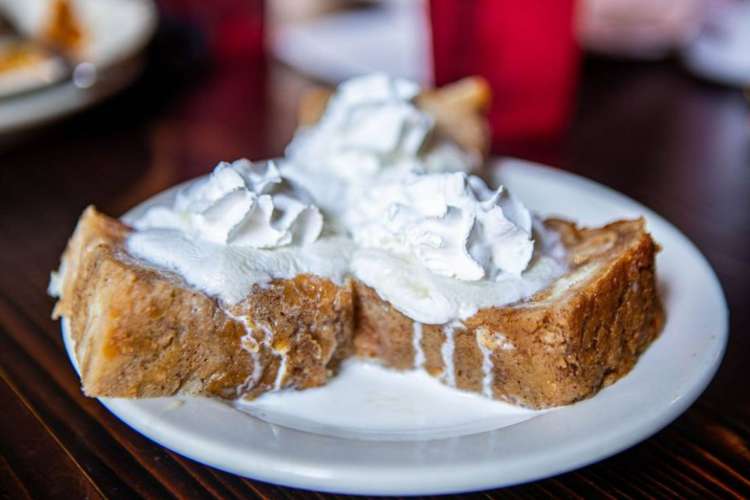 three pieces of dessert bread with whipped cream piled on top