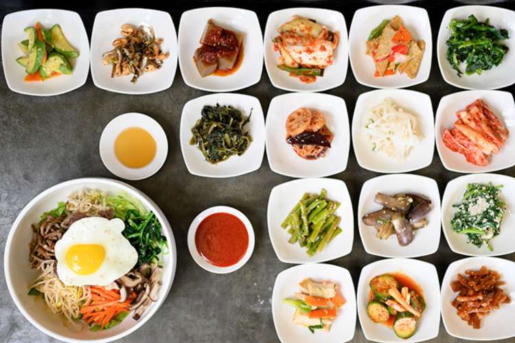 Korean bibimbap laid out with a variety of side dishes