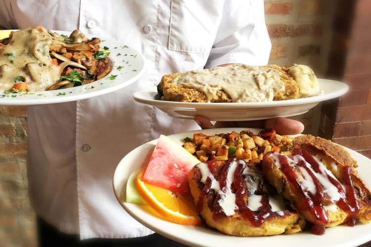 chef holding plates at the chicago diner