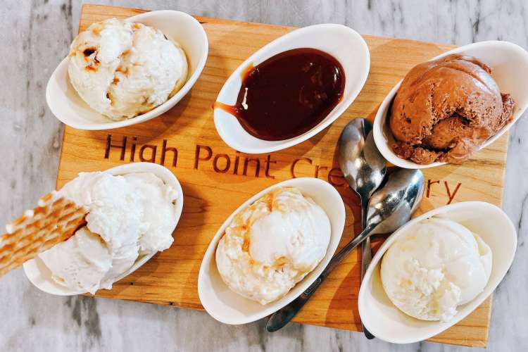 a platter of five small ice cream dishes and one dark sauce from High Point Creamery