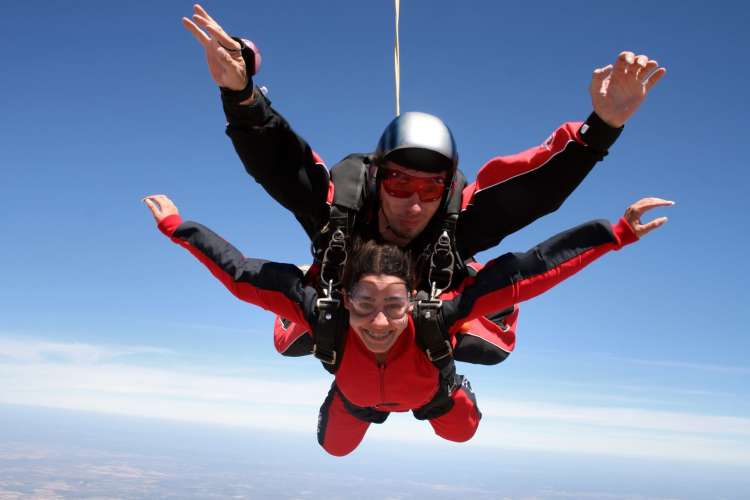 A woman falling through the air during a tandem skydive