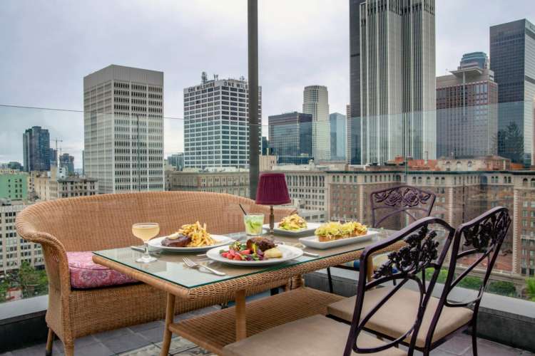 a table with food next to a high window in Downtown Los Angeles.