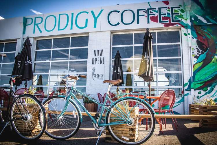 exterior view of Prodigy Coffee House with parked bikes and outdoor seating 