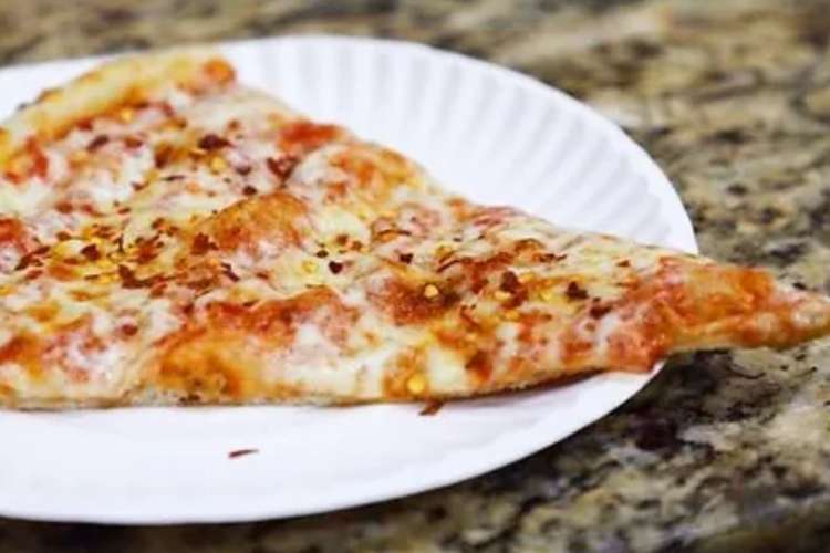 slice of pizza on a paper plate