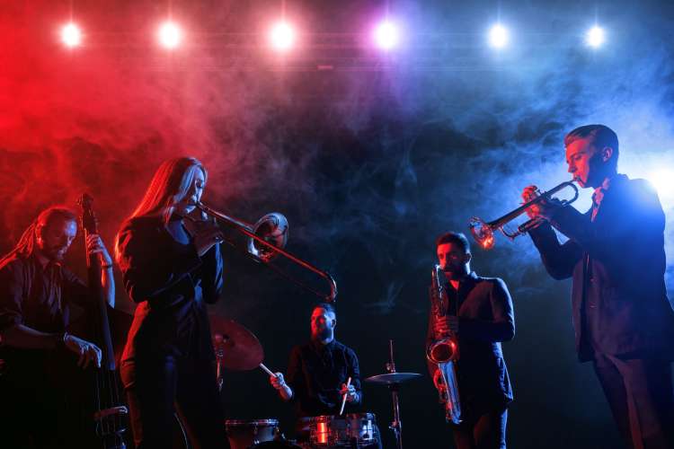 a jazz band plays on a spotlighted stage