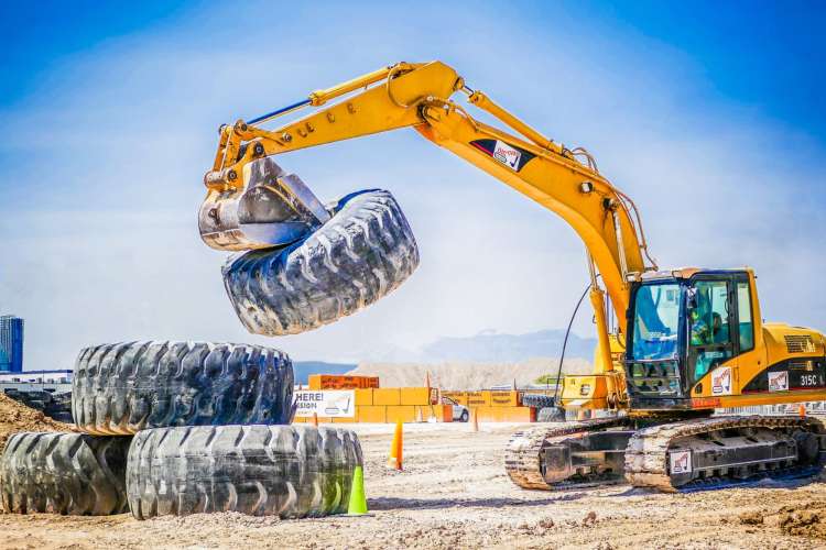A person operating a crane at Dig This!, a fun place to go for a team building activity in Las Vegas 
