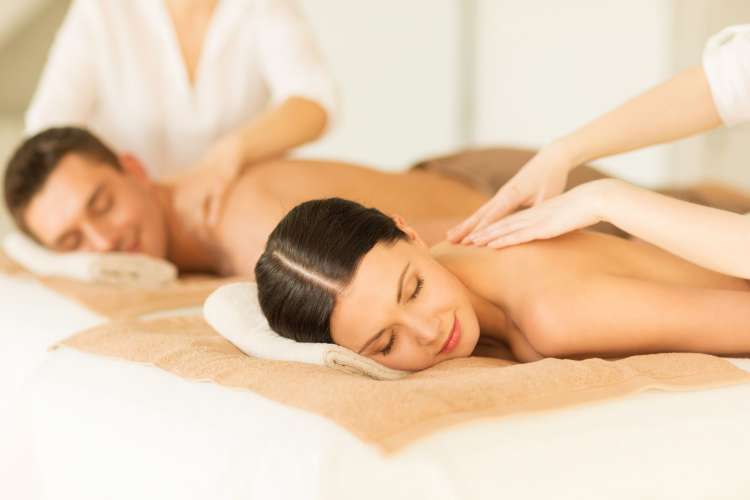 a man and woman receive body massages