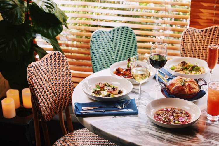 a colorful scene of dishes and wine glasses