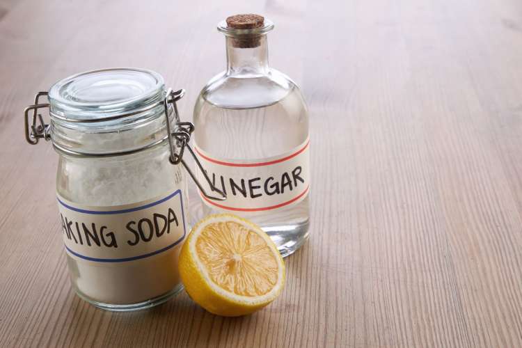 baking soda, lemon, and vinegar on a table