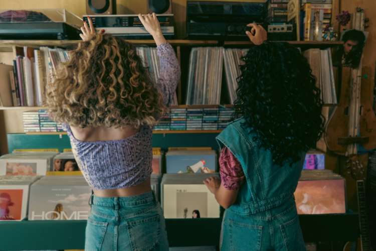 Two women picking out records at a record store