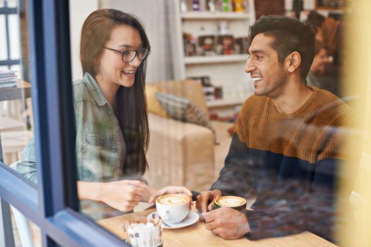 a couple having coffee together in a coffee shop