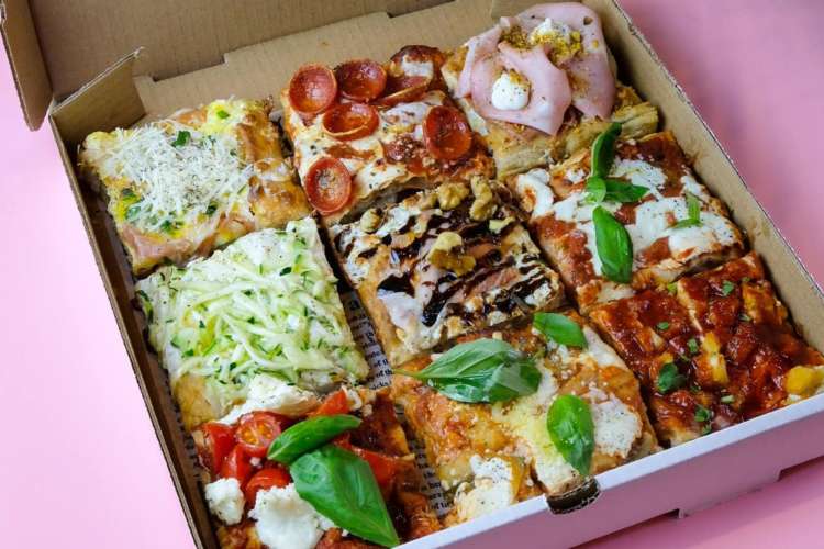 a boxed pizza divided into six different flavors