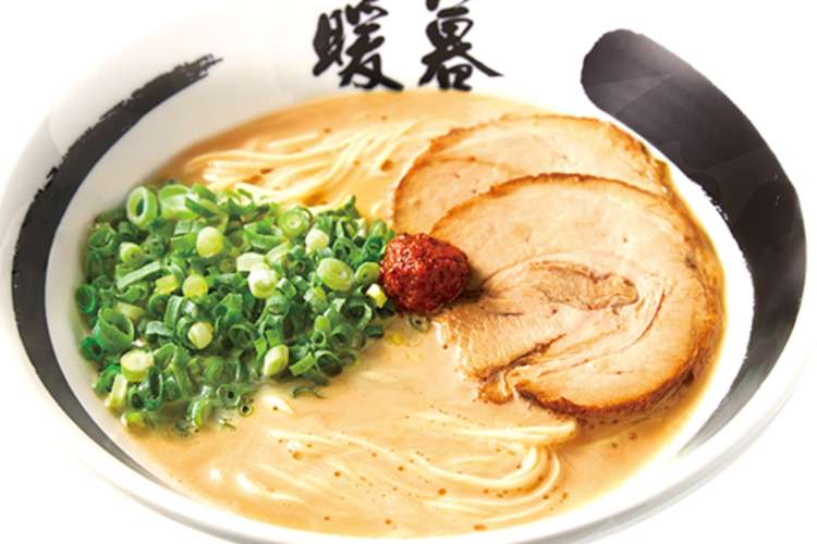 a ramen bowl with pork, scallions, and red paste