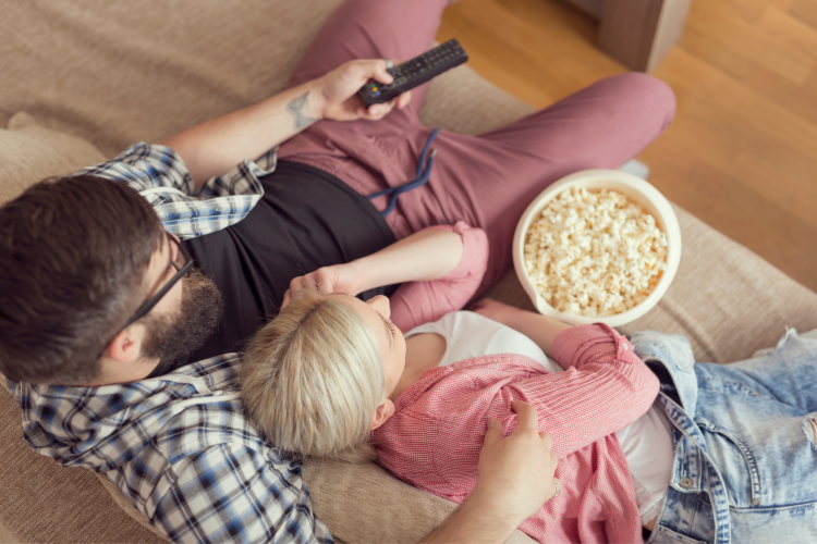 couple watching tv on the couch