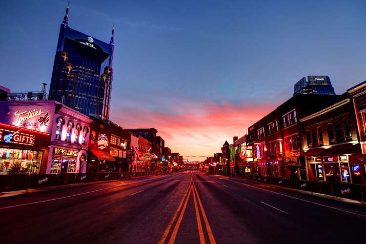 the thoroughfare of Broadway district in Nashville during a vivid sunset