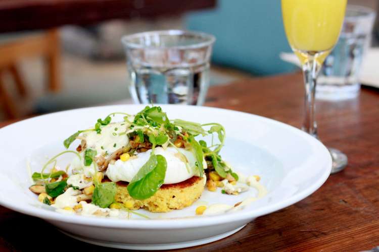 eggs Benedict and a mimosa on a table