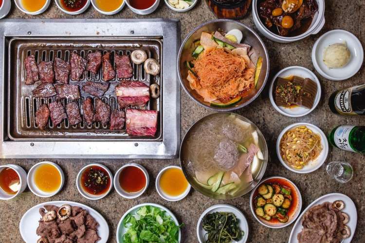 An array of Korean barbecue, soups, noodles, and sides