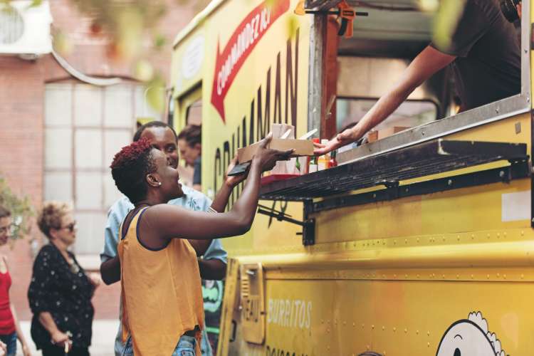 two women ordering from a food truck