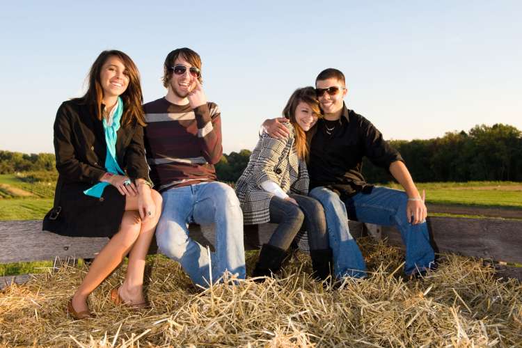 two couples sitting together on a hayride