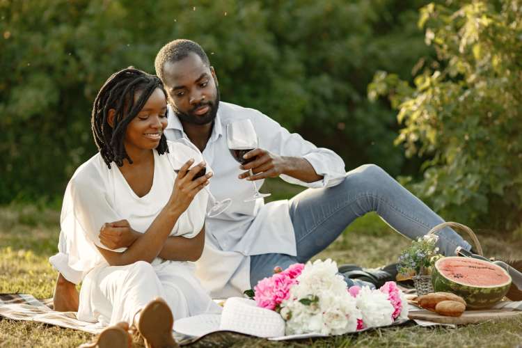 a couple drinking wine during a tranquil picnic