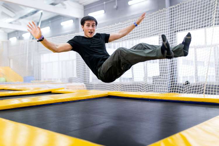 a man jumping on a trampoline 