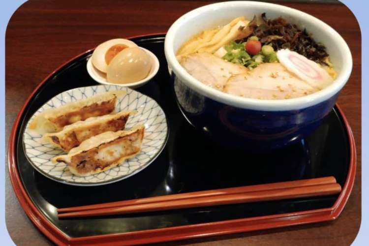 ramen, an egg, and gyoza on a serving dish