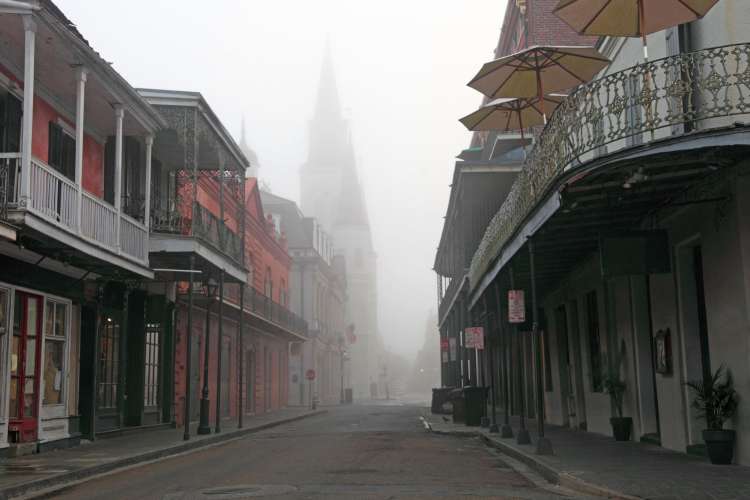 a view of the French Quarter with a church steeple rising out of fog