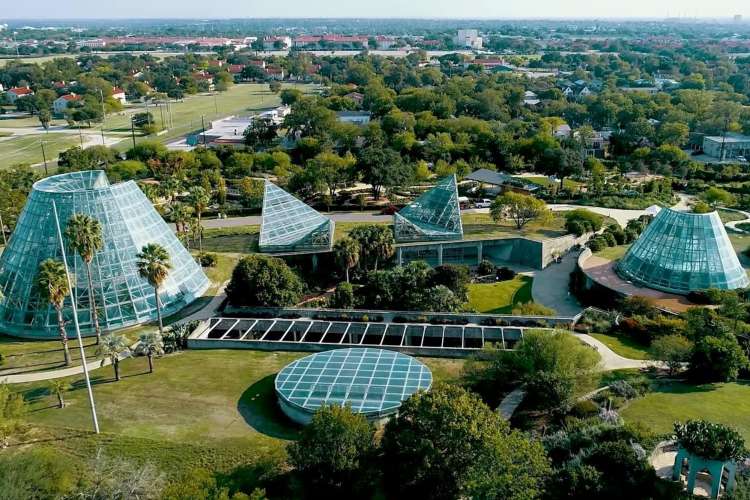 aerial view of five uniquely shaped hothouses in a botanical garden