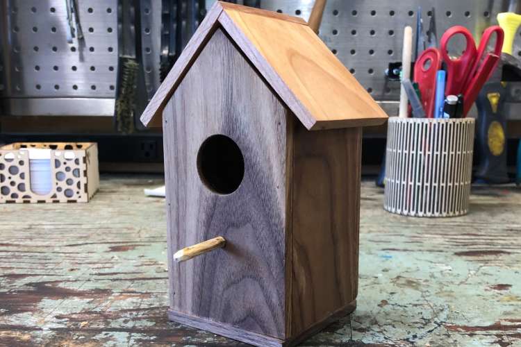 a wooden birdbox on a worktable