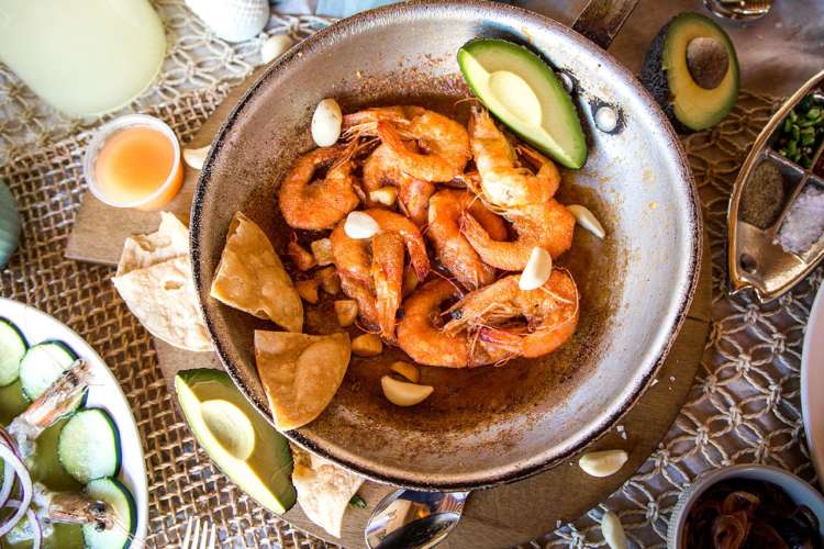 a bowl of shrimp and garnishes