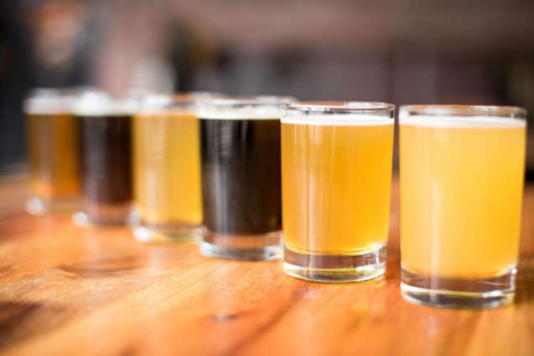 a flight of different beers in a row