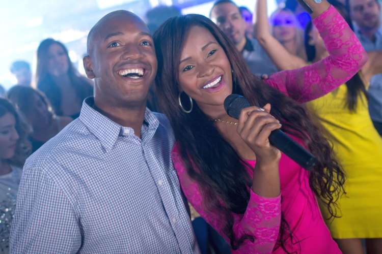 Singing karaoke is a fun second date idea for music lovers.