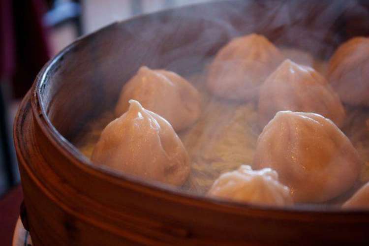 hot Taiwanese style soup dumplings steaming in a basket