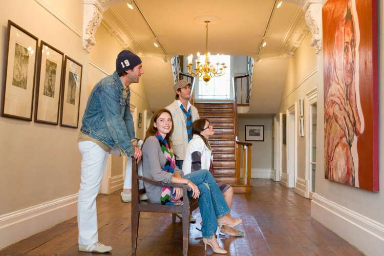 Four people appreciating art at a museum — a great one-year anniversary date idea