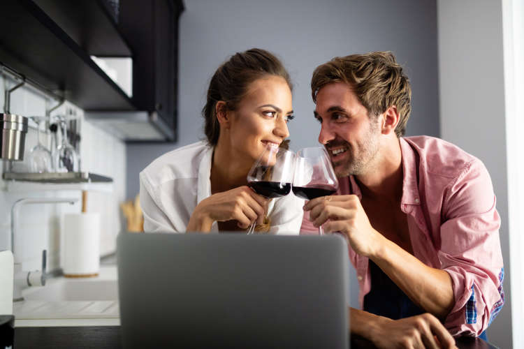 couple at home taking online cooking classes and online mixology classes