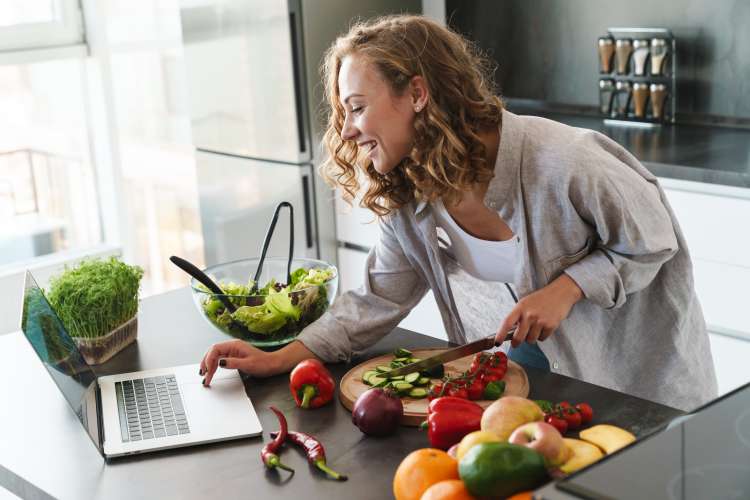 young woman in the kitchen taking a vegan online cooking class