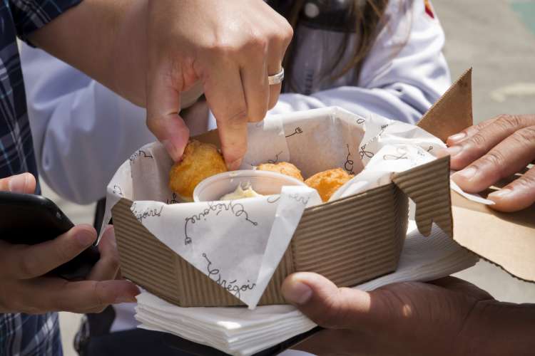 eating croquettes on a walking city food tour