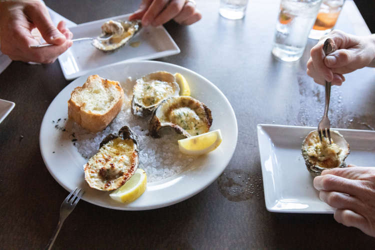 enjoying oysters rockefeller on a food tour