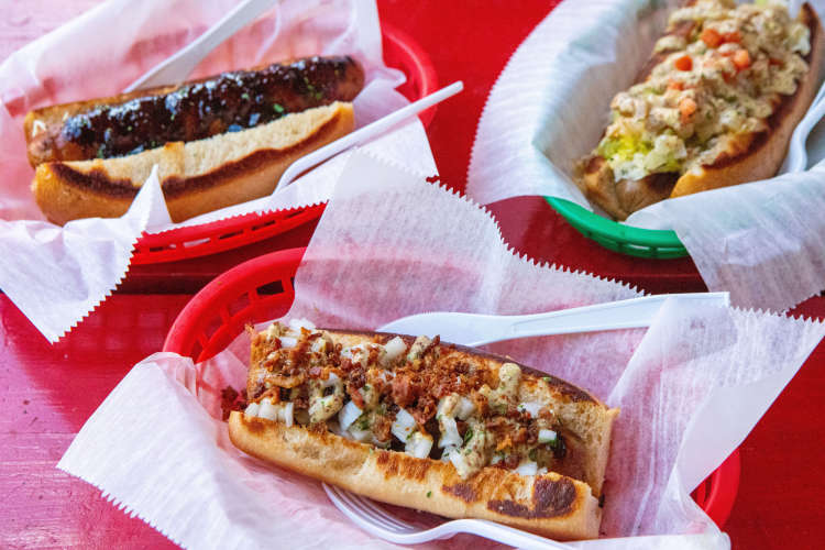 various hotdogs with toppings on a food tour