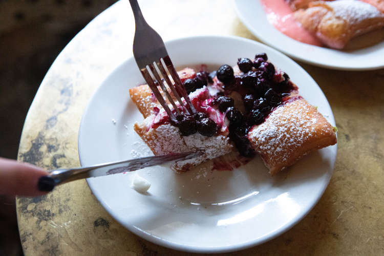 enjoying beignets on a food tour