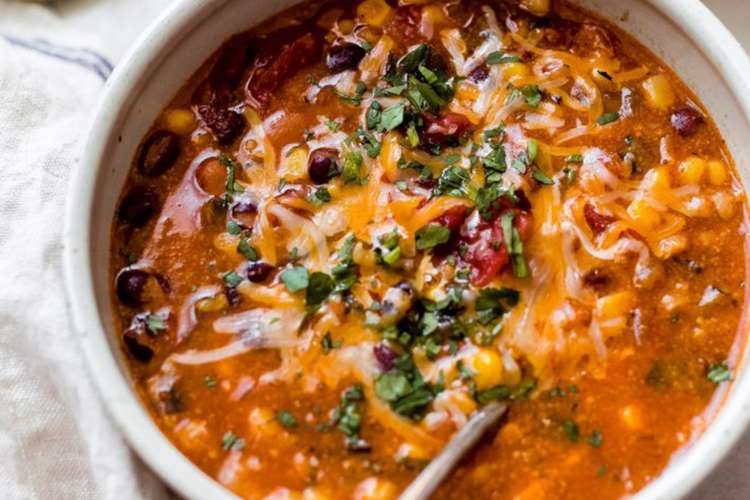 easy cheesy bean and rice enchilada soup is a warm and comforting vegetarian soup recipe