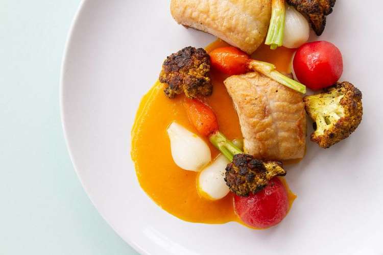 fish and roasted vegetables on a plate during a private chef experience