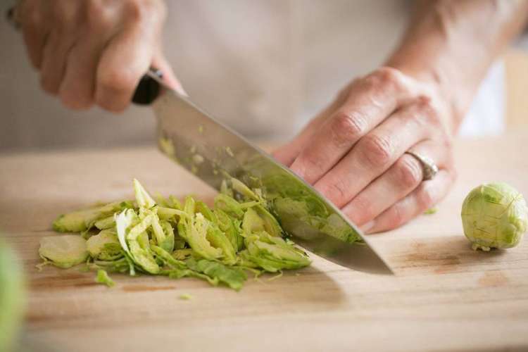 chef chopping brussels sprouts