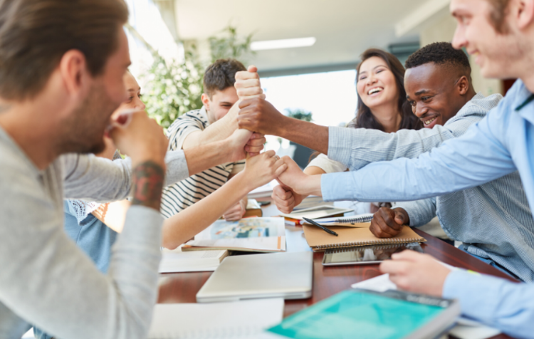 People stacking their fists on each other during an ice breaker game