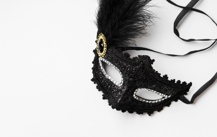 A black mask on a white background, which is perfect for a masquerade ball as a 50th birthday party idea