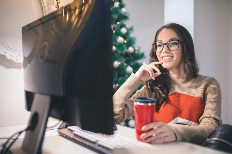 young woman playing holiday clips game with friends virtually