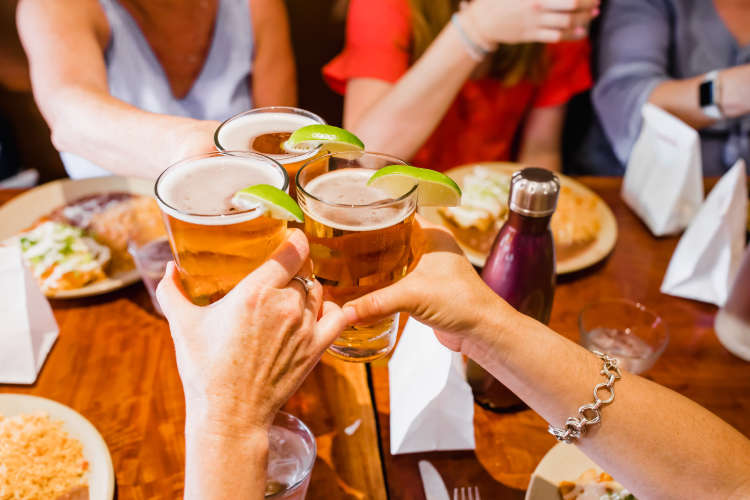 friends toasting beers on a food tour